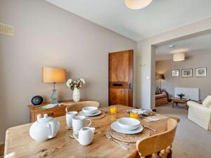 a dining room table with white dishes on it at 1 Bed in York oc-84002 in Crayke