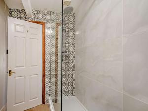 a bathroom with a shower with a glass door at 1 Bed in York oc-84002 in Crayke +13 photos