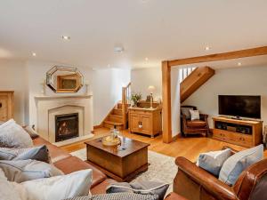a living room with a couch and a fireplace at 4 Bed in Frome oc-27808 in Holwell