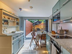 a kitchen with a counter and a table with chairs at 3 Bed in Montacute oc-92227 in Montacute +14 photos
