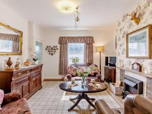 a living room with a table and a fireplace at 2 Bed in Consett oc-92807 in Hunstanworth