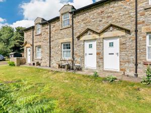a brick house with white doors and a table at 2 Bed in Consett oc-92807 in Hunstanworth