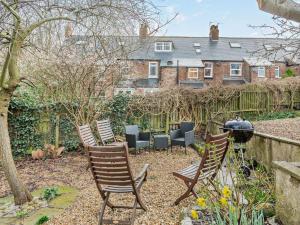 a group of chairs and a grill in a garden at 3 Bed in Ripon oc-94477 in Ripon
