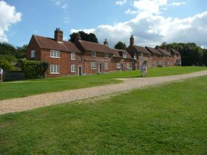 a row of red brick houses on a grass field at 2 Bed in Beaulieu oc-nfl71 in Beaulieu +7 photos