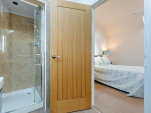 a bathroom with a shower and a door to a bedroom at 2 Bed in Driffield oc-79280 in Wold Newton +14 photos