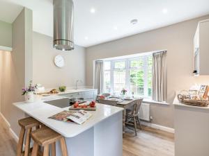 a kitchen with a large white island and a table at 2 Bed in York oc-84000 in Crayke +11 photos