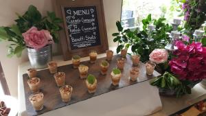 a table with small plants in small cups on it at Inisheer Hotel (Óstán Inis Oírr) in Inisheer