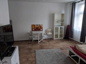 a living room with two chairs and a table at Wohnung Burgstraße in Wittenberge