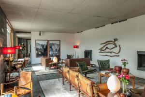 a living room with chairs and a couch and a table at Quinta do Vallado - Douro Wine Hotel in Peso da Régua