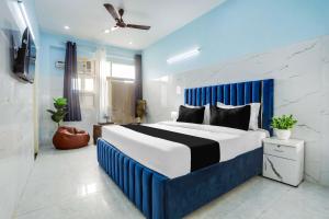 a blue and white bedroom with a large bed at Hotel O Safe & Sure Residency in Gurgaon