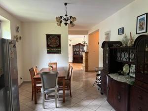 a kitchen and dining room with a table and chairs at Dom Acapulco in Kromszewice +9 photos