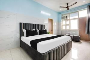a bedroom with a large bed in a room at Hotel O Safe & Sure Residency in Gurgaon