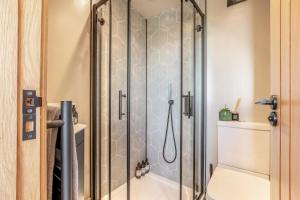 a shower with a glass door in a bathroom at 1 Bed in Austwick oc-b37509 in Austwick +14 photos