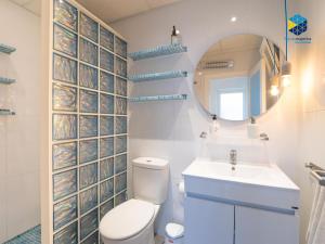 a bathroom with a toilet and a sink and a mirror at Can Tassi in Porto Cristo +26 photos