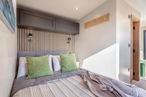 a bedroom with a large bed with green pillows at 1 Bed in Austwick oc-b37509 in Austwick