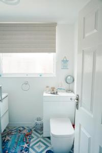a bathroom with a toilet and a window at Chalet 80 in Sandown +24 photos
