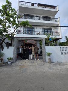 a group of people standing in front of a building at Tam Coc Natura Hotel in Văn Lâm