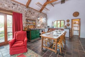a large kitchen with a wooden table and chairs at Crabhall Barn in Haverfordwest