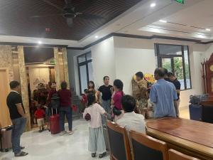 a group of people standing in a room at Tam Coc Natura Hotel in Văn Lâm