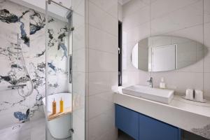 a bathroom with a sink and a shower at 藤夏日光 in Weiqian +15 photos