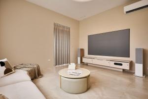 a living room with a large flat screen tv at 藤夏日光 in Weiqian