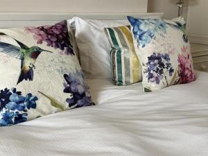 a bed with pillows and a bird on it at Pembroke Villa in Shanklin