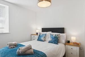 a bedroom with a bed with blue and white pillows at 2 Bed in Aberystwyth oc-c36918 in Aberystwyth