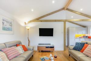a living room with two couches and a flat screen tv at 3 Bed in Winnards Perch oc-m30557 in Saint Columb Major