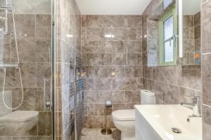 a bathroom with a shower and a toilet and a sink at 3 Bed in Winnards Perch oc-m30557 in Saint Columb Major +20 photos