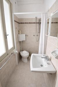 a bathroom with a sink and a toilet and a shower at Camere Capinera in Cesenatico