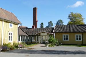 a house with a chimney on top of it at Strömbäcks Vandrarhem in Umeå