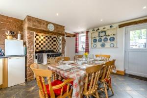 a kitchen with a table and chairs and a refrigerator at 3 Bed in Scaleby oc-b33069 in Scaleby
