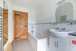 a bathroom with a sink and a tub and a mirror at 3 Bed in Scaleby oc-b33069 in Scaleby +21 photos