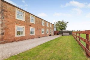 an exterior view of a brick house with a fence at 3 Bed in Scaleby oc-b33069 in Scaleby