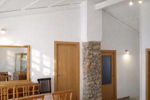 a room with a stone pillar and a mirror at Casa Rural Las Camilas- Sierra de Alcaraz in Vianos +15 photos