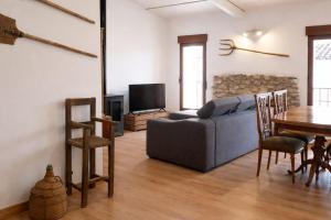 a living room with a couch and a table at Casa Rural Las Camilas- Sierra de Alcaraz in Vianos