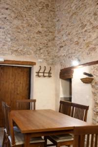 a dining room with a wooden table and chairs at Casa Rural Las Camilas- Sierra de Alcaraz in Vianos