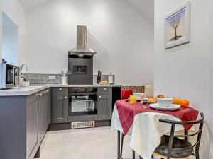 a kitchen with a table with a red table cloth at 1 Bed in Pickering oc-96309 in Allerston