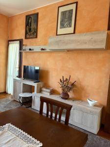 a living room with a table and a tv at Gere house in Lezzeno