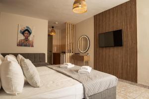 a bedroom with a bed with two towels on it at Aggire Summer Suites in Alikanas