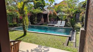 a swimming pool in the backyard of a house at Werkudara Guest House in Ubud