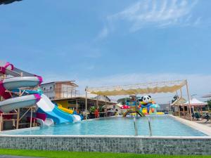 a water park with a water slide and a pool at Nan Minimal ที่พักน่านมินิมอล in Ban Na Tho