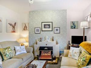 a living room with a couch and a fireplace at 2 Bed in Consett oc-96375 in Hunstanworth