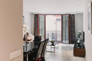 a woman sitting at a table in a living room at Signa Juristas in Valencia