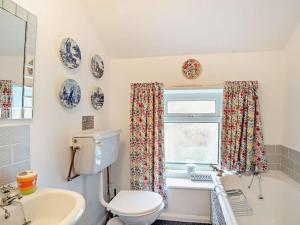 a bathroom with a toilet and a sink and a window at 2 Bed in Consett oc-96375 in Hunstanworth +16 photos