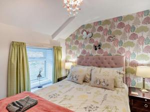 a bedroom with a bed with a pink head board at 2 Bed in Consett oc-96375 in Hunstanworth