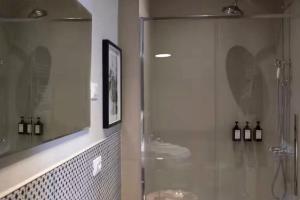 a bathroom with a glass shower and a sink at Casa Martinez Relax Cles in Cles