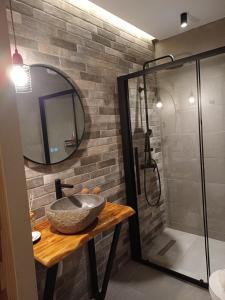 a bathroom with a stone sink and a shower at Traditional Guesthouse Vrigiis in Agios Germanos