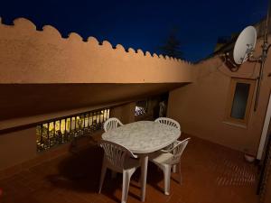 a table and chairs on a patio at night at Ático centro Benicasim in Benicàssim