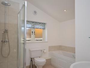 a bathroom with a toilet and a shower and a sink at 3 Bed in Bristol oc-58129 in Burrington
